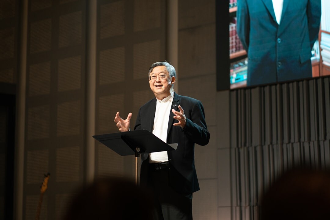 Public speaker presenting on stage at conference